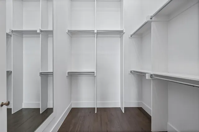 an empty closet with wooden floor