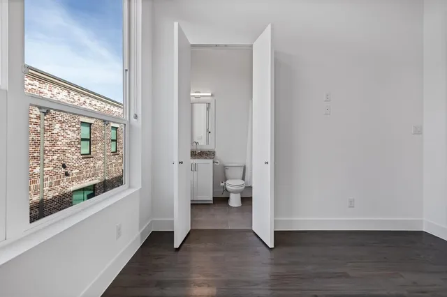 a view of an empty room and wooden floor