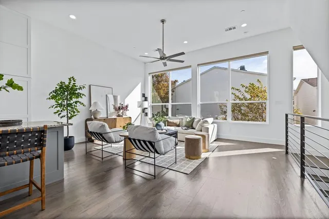 a living room with furniture a dining table and a potted plant
