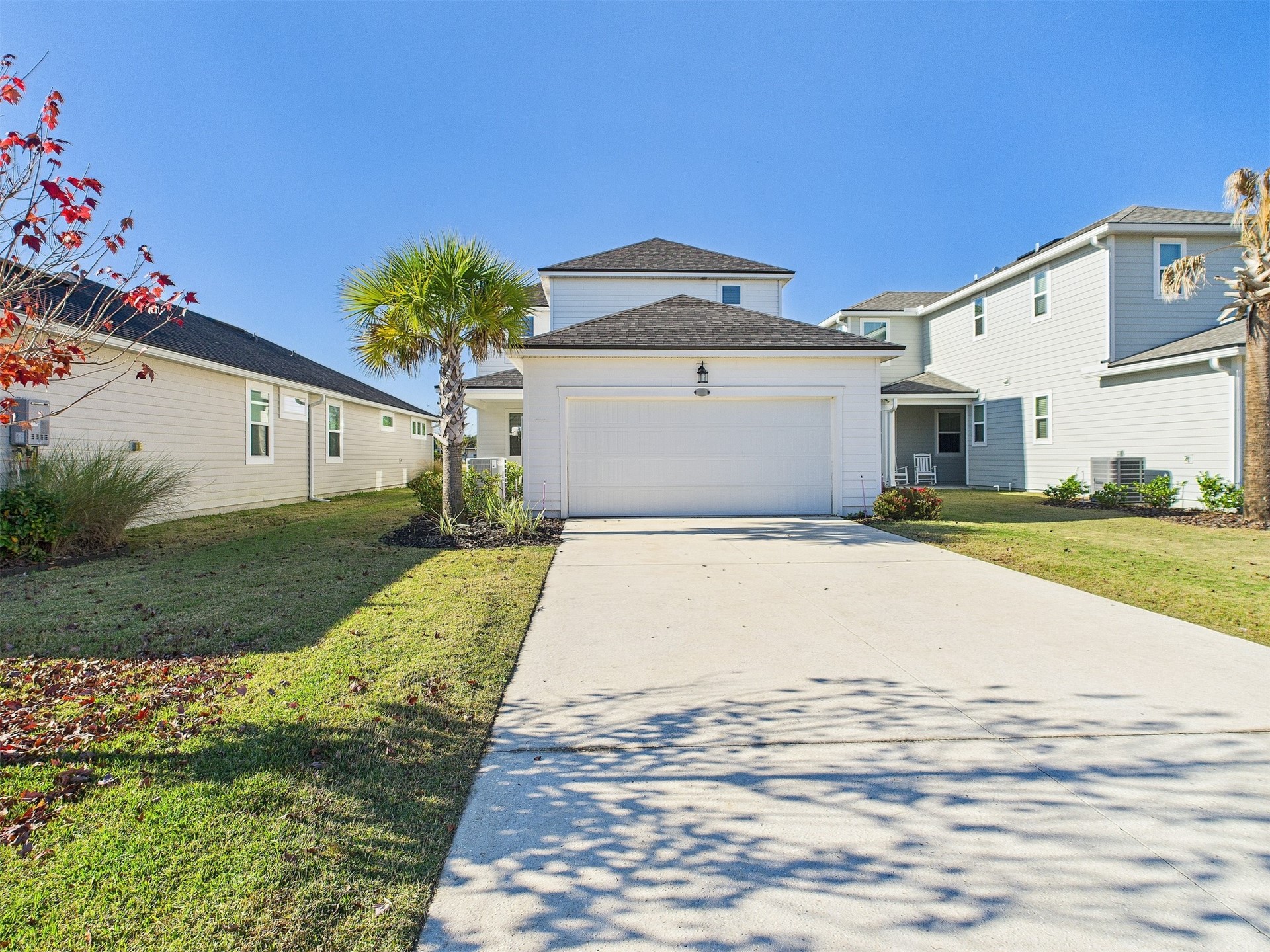 253 Spartina Lane Yulee, FL 32097 - Photo 17 of 22 Rear-entry 2-car garage features an extended driveway, offering rare and abundant parking space for guests or extra vehicles.