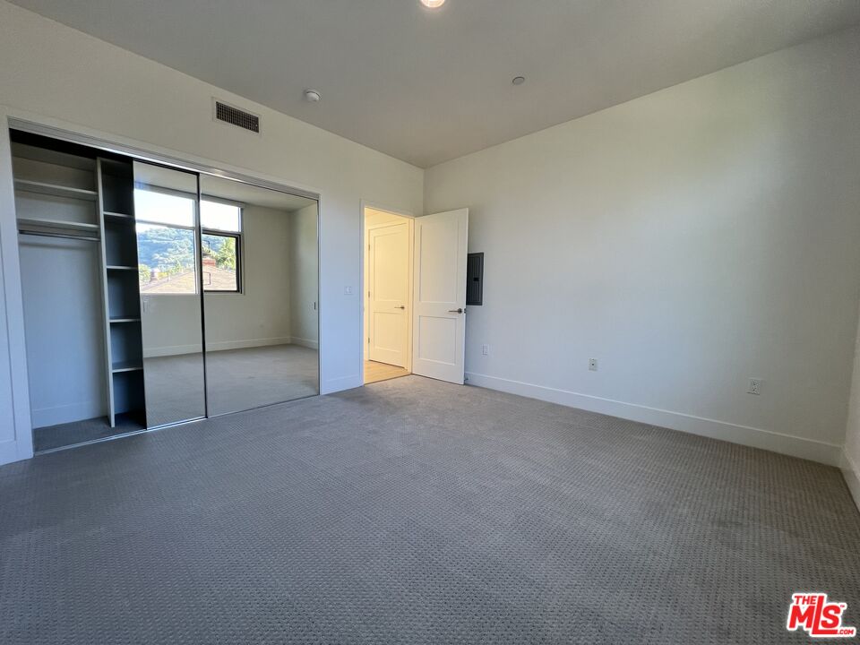 11715 Bellagio Road, Unit 305 Los Angeles, CA 90049 - Photo 13 of 25 an empty room with windows