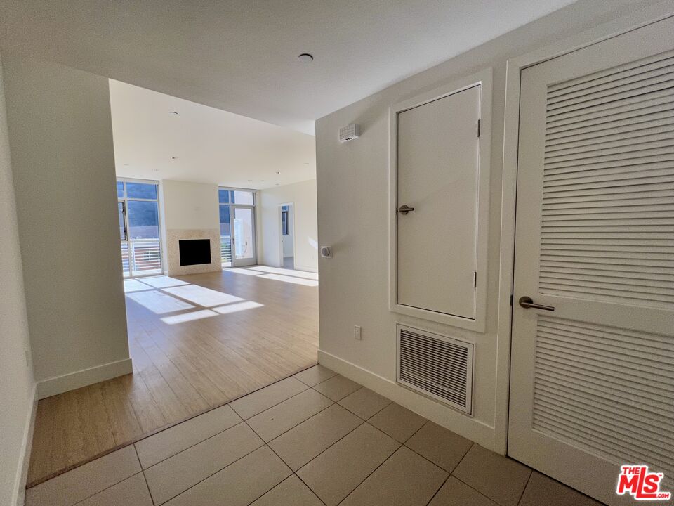 11715 Bellagio Road, Unit 305 Los Angeles, CA 90049 - Photo 2 of 25 a view of kitchen with refrigerator cabinets and stove top oven