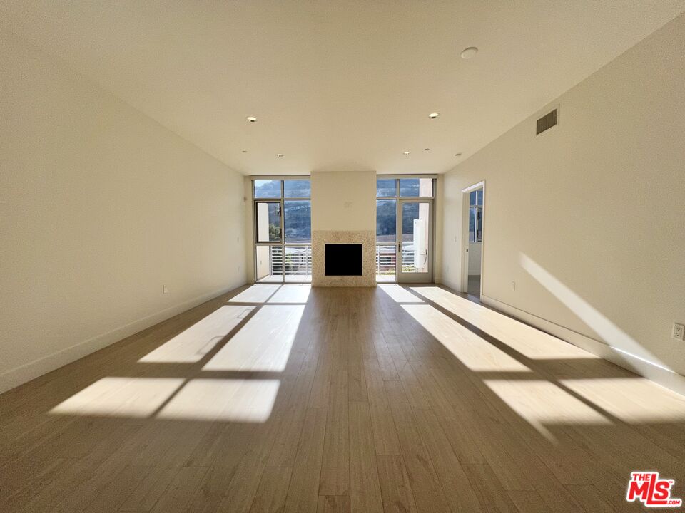 11715 Bellagio Road, Unit 305 Los Angeles, CA 90049 - Photo 6 of 25 a view of a living room with a large window