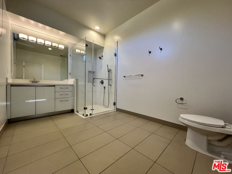 11715 Bellagio Road, Unit 305 Los Angeles, CA 90049 - Photo 10 of 25 a bathroom with a sink a toilet and a shower