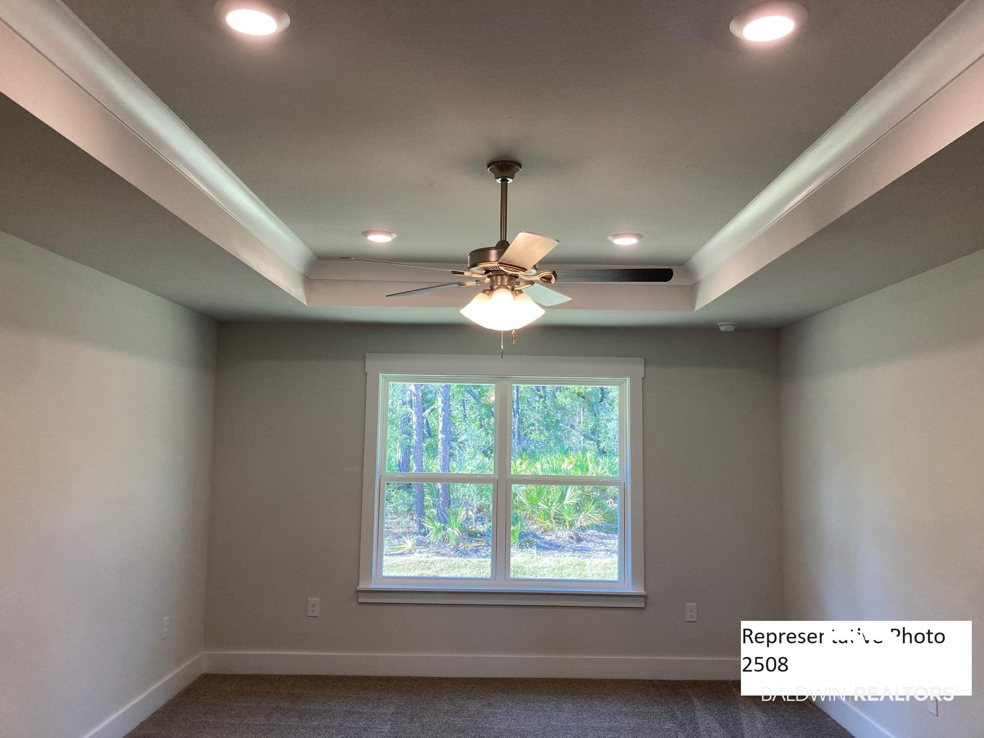 2201 Pollard Road Daphne, AL 36526 - Photo 13 of 15 Carpeted empty room featuring ceiling fan and a raised ceiling