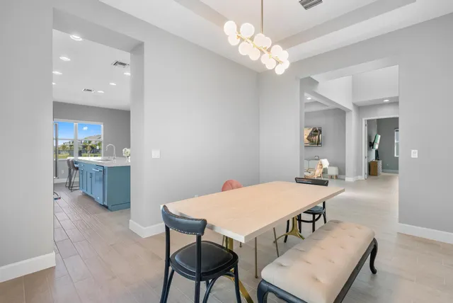a view of a dining room with furniture and chandelier