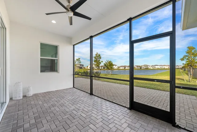 a view of an empty room with a floor to ceiling window and an outdoor view
