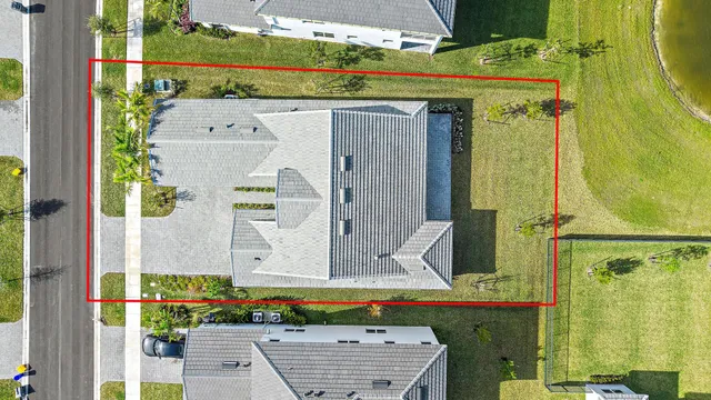 an aerial view of a house with a big yard