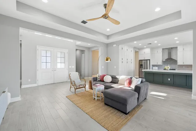 a living room with furniture and kitchen view
