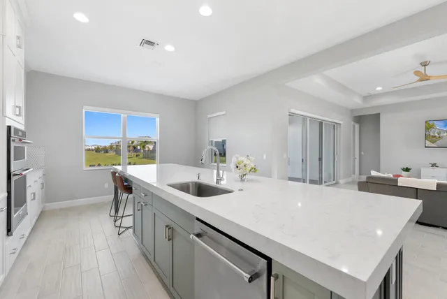 a kitchen with a sink a counter top space and stainless steel appliances