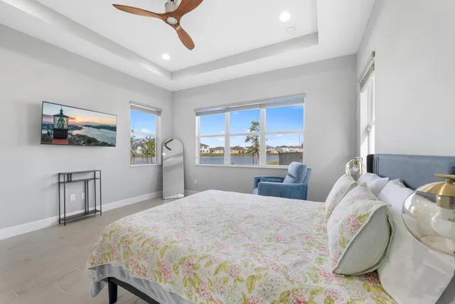 a bedroom with a bed mirror and a window