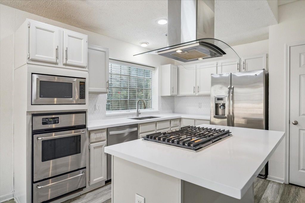 143 West Village Knoll Circle Spring, TX 77381 - Photo 11 of 27 Alternate view of the kitchen and Breakfast room that looks out onto the deck and backyard.