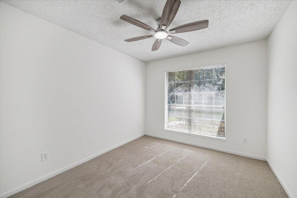 143 West Village Knoll Circle Spring, TX 77381 - Photo 13 of 27 Bedroom with fresh paint and carpet.