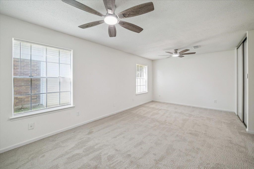 143 West Village Knoll Circle Spring, TX 77381 - Photo 17 of 27
The generously sized primary bedroom offers plenty of space to create your perfect retreat. Easily accommodates a king-sized bed, additional furniture, or even a cozy seating area or workspace. With its flexible layout and serene atmosphere, this room is designed for comfort and personal style.