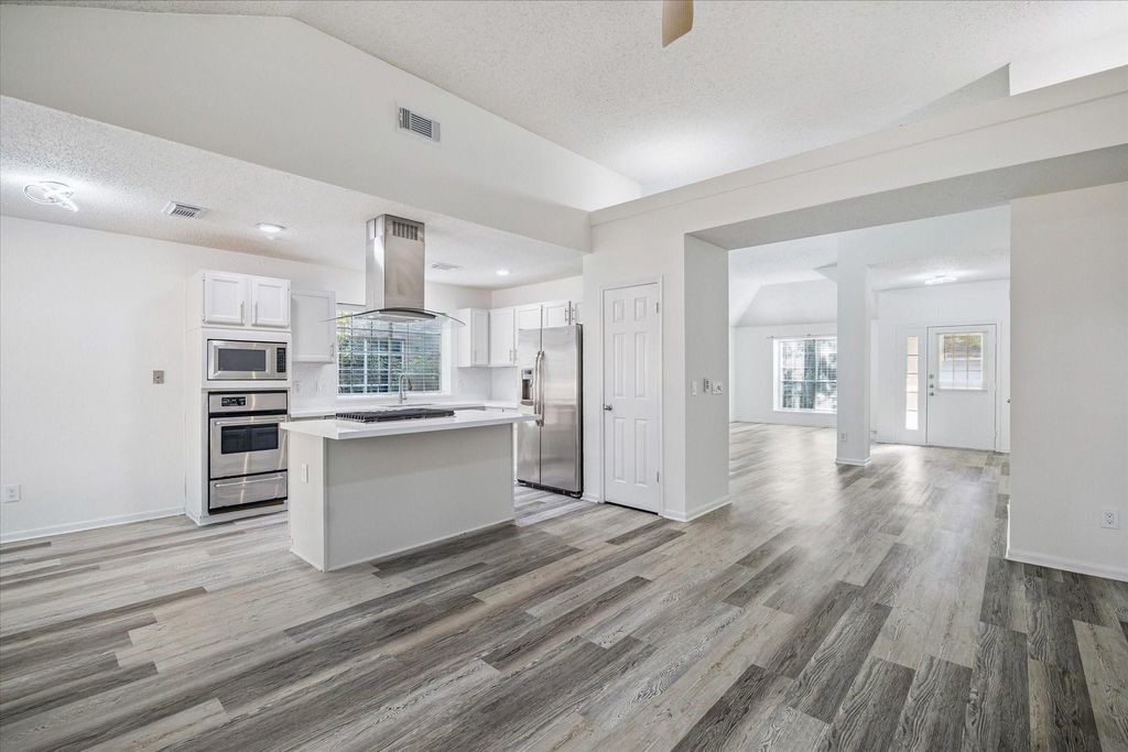 143 West Village Knoll Circle Spring, TX 77381 - Photo 5 of 27 Welcoming and adaptable, this space offers high ceilings, stylish wood-look flooring, and a front-facing window that brings in abundant natural light.