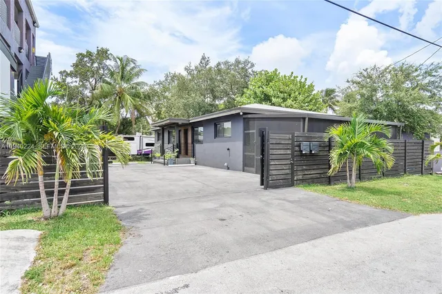 a view of a house with a yard and garage