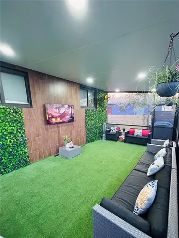 a living room with furniture and a garden