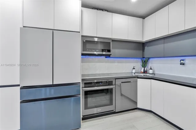 a kitchen with a sink and a refrigerator