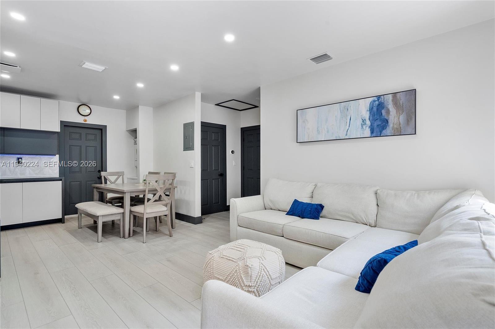 100 Northeast 71st Street, Unit 100 Miami, FL 33138 - Photo 5 of 15 a living room with furniture and kitchen view