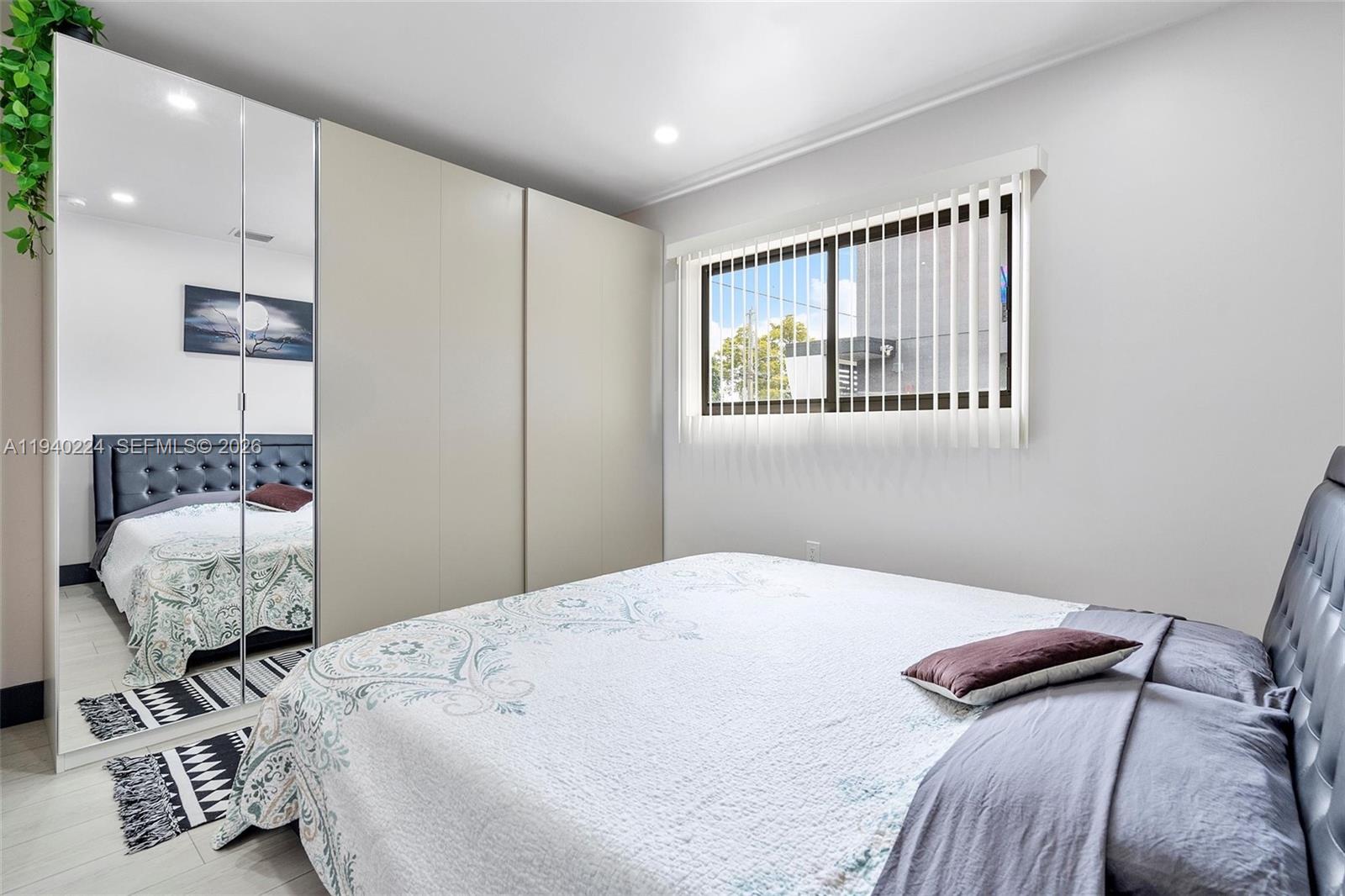 100 Northeast 71st Street, Unit 100 Miami, FL 33138 - Photo 8 of 15 a bedroom with a bed and a window