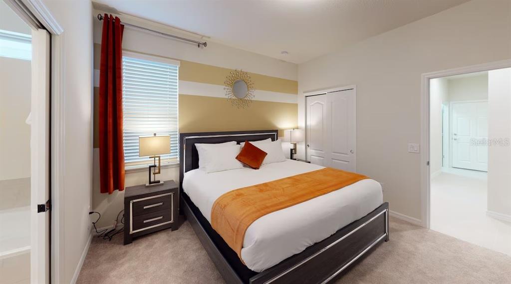 2479 Dubai Street Kissimmee, FL 34747 - Photo 11 of 70 a bedroom with a bed and a night stand