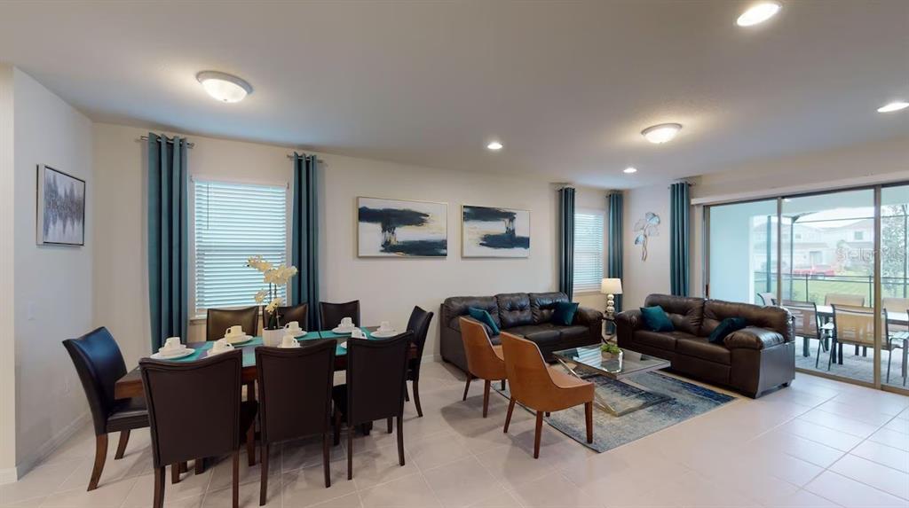 2479 Dubai Street Kissimmee, FL 34747 - Photo 19 of 70 a living room with furniture a large window and a dining table