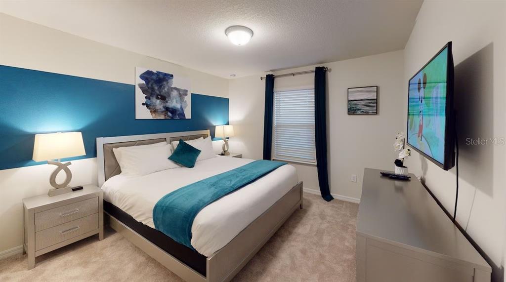 2479 Dubai Street Kissimmee, FL 34747 - Photo 20 of 70 a bedroom with a bed and a flat screen tv