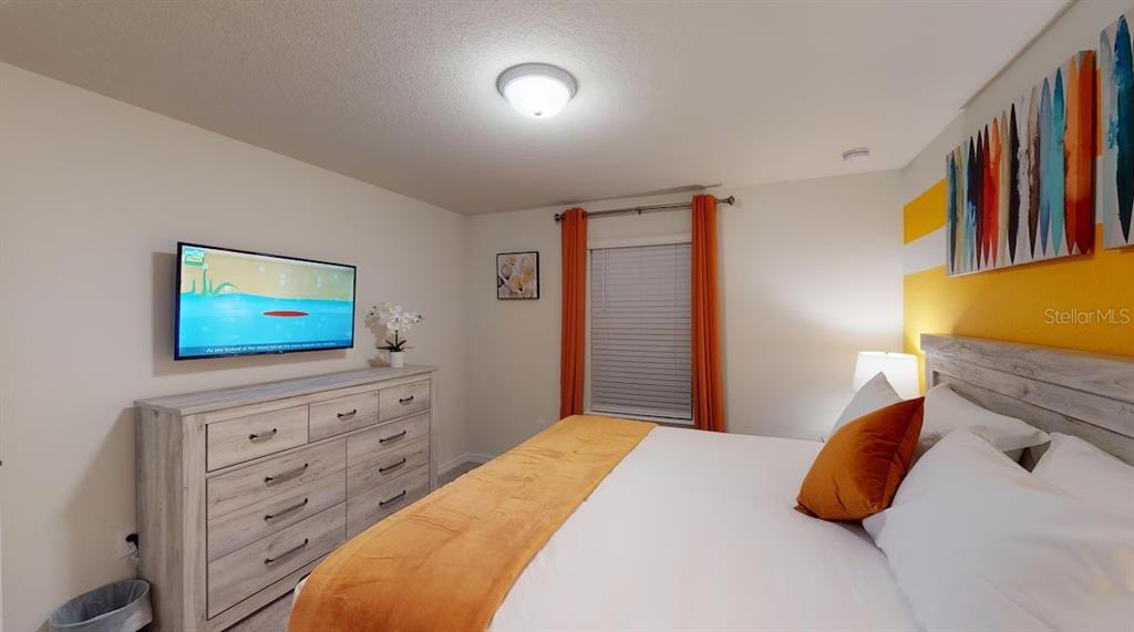 2479 Dubai Street Kissimmee, FL 34747 - Photo 22 of 70 a bedroom with a bed and a flat screen tv