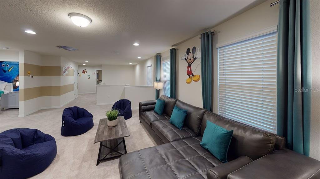 2479 Dubai Street Kissimmee, FL 34747 - Photo 35 of 70 a living room with furniture and a potted plant