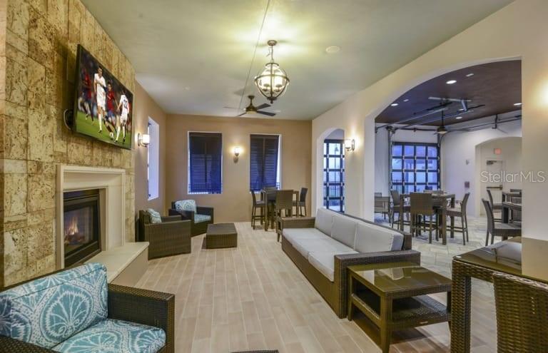 2479 Dubai Street Kissimmee, FL 34747 - Photo 63 of 70 a living room with furniture a fireplace and a flat screen tv