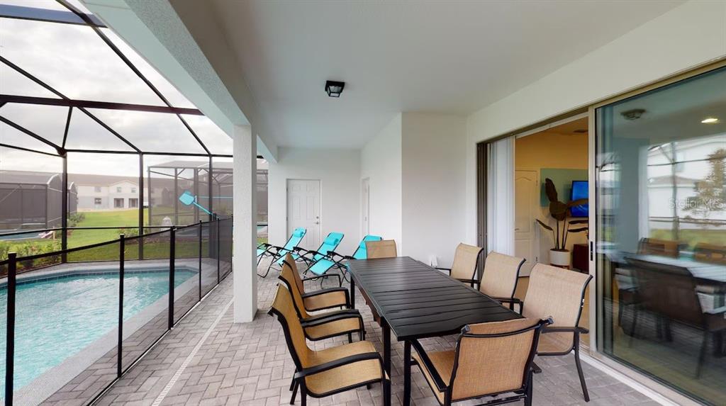 2479 Dubai Street Kissimmee, FL 34747 - Photo 8 of 70 a dining room with furniture and a floor to ceiling window