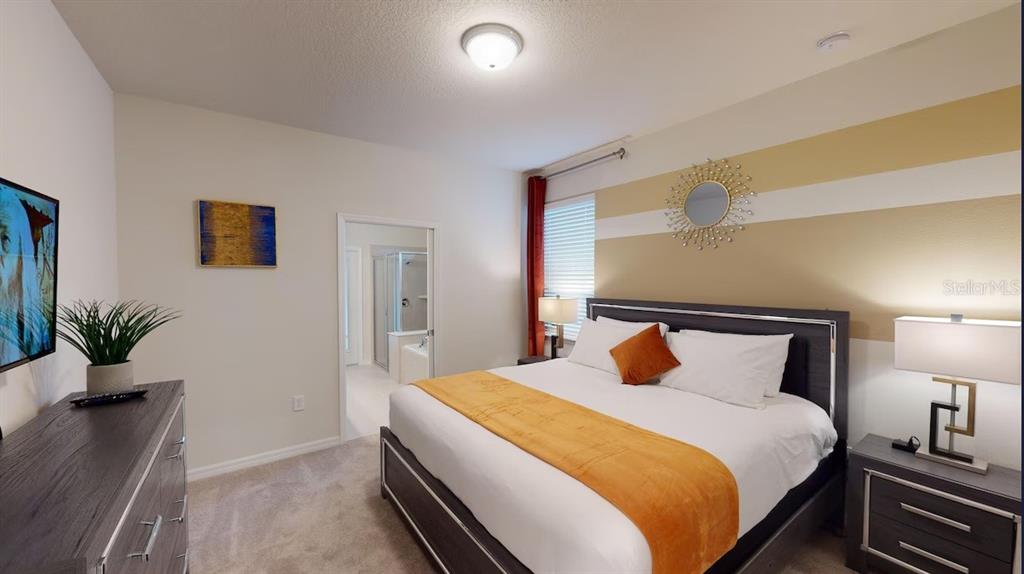 2479 Dubai Street Kissimmee, FL 34747 - Photo 10 of 70 a bedroom with a large bed and potted plant