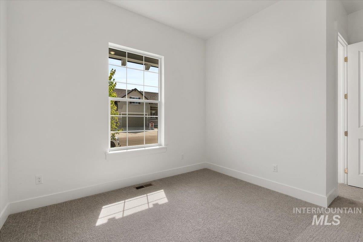 929 North Falling Water Way Eagle, ID 83616 - Photo 11 of 43 Unfurnished room featuring baseboards and carpet flooring