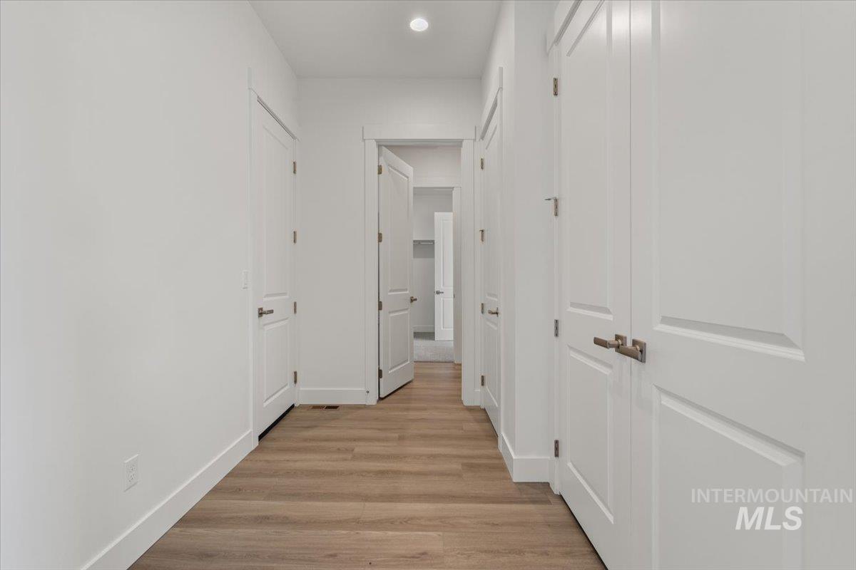 929 North Falling Water Way Eagle, ID 83616 - Photo 16 of 43 Hallway with light wood finished floors and recessed lighting