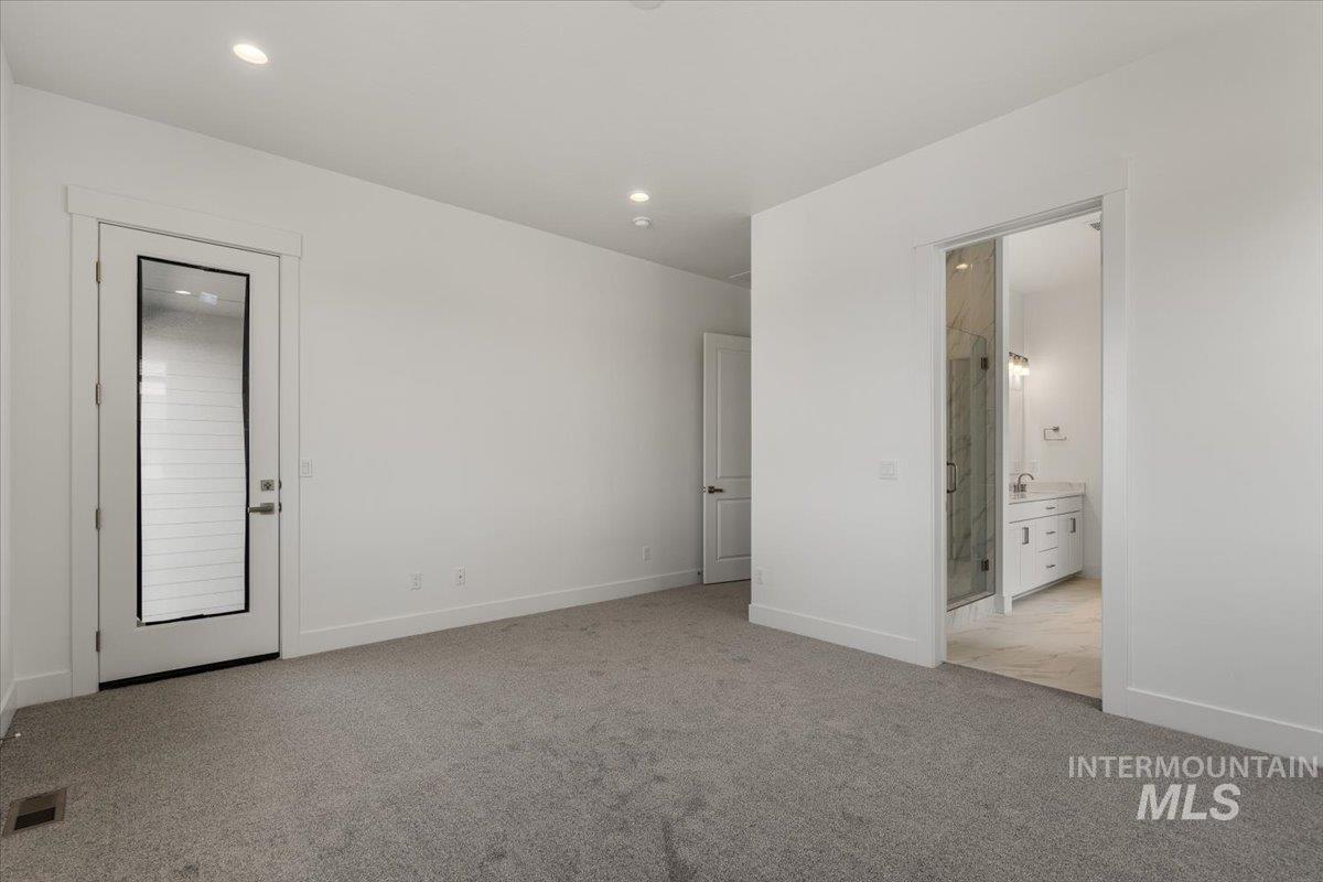 929 North Falling Water Way Eagle, ID 83616 - Photo 30 of 43 Unfurnished bedroom with light colored carpet, ensuite bathroom, and recessed lighting