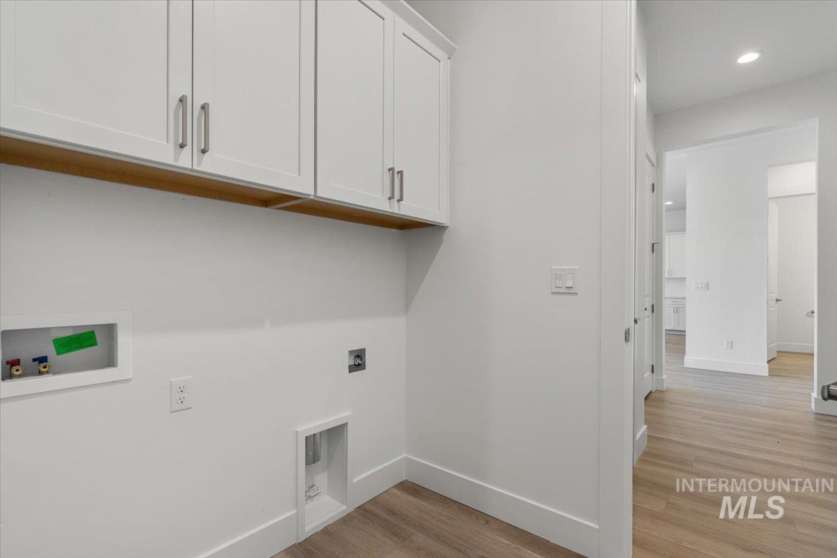 929 North Falling Water Way Eagle, ID 83616 - Photo 36 of 43 Laundry room with light wood-style floors, washer hookup, recessed lighting, cabinet space, and electric dryer hookup