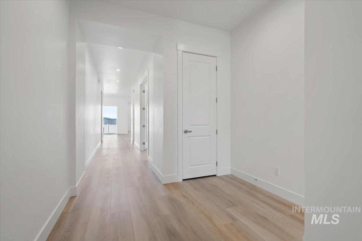 929 North Falling Water Way Eagle, ID 83616 - Photo 5 of 43 Hallway featuring light wood-type flooring and baseboards