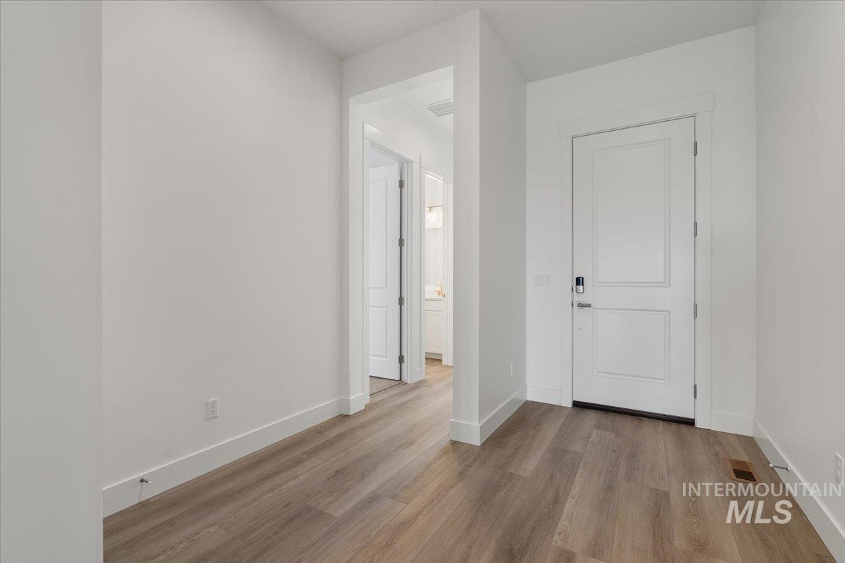 929 North Falling Water Way Eagle, ID 83616 - Photo 6 of 43 Unfurnished room with baseboards and light wood-style floors