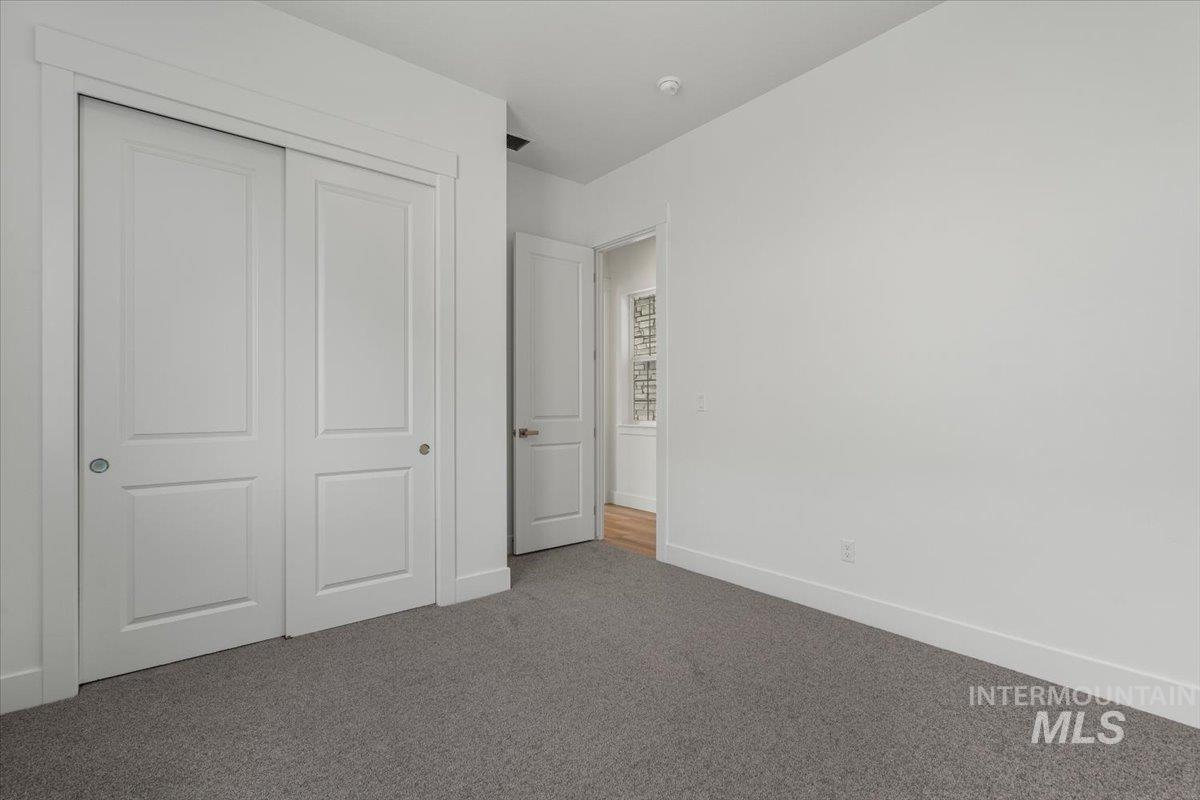 929 North Falling Water Way Eagle, ID 83616 - Photo 8 of 43 Unfurnished bedroom featuring carpet and a closet