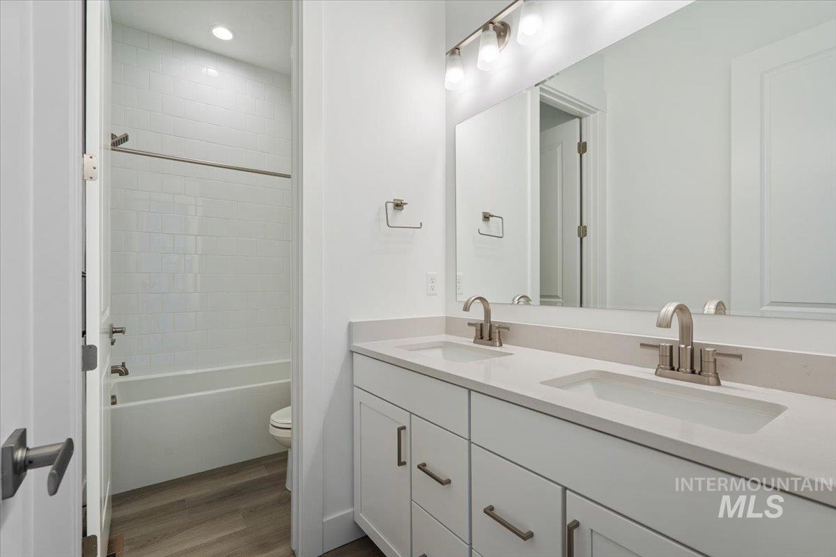 929 North Falling Water Way Eagle, ID 83616 - Photo 9 of 43 Full bath featuring dark wood-style flooring, double vanity, and shower / bathtub combination