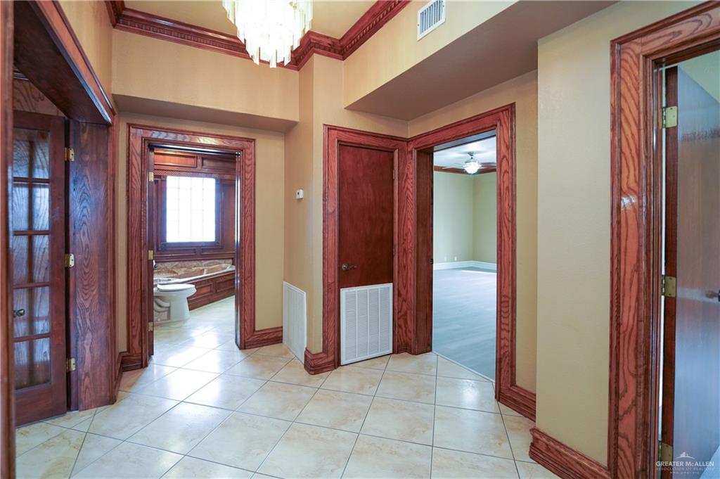 3178 El Campo Road Rio Grande City, TX 78582 - Photo 27 of 40 a view of a hallway and a livingroom with a chandelier