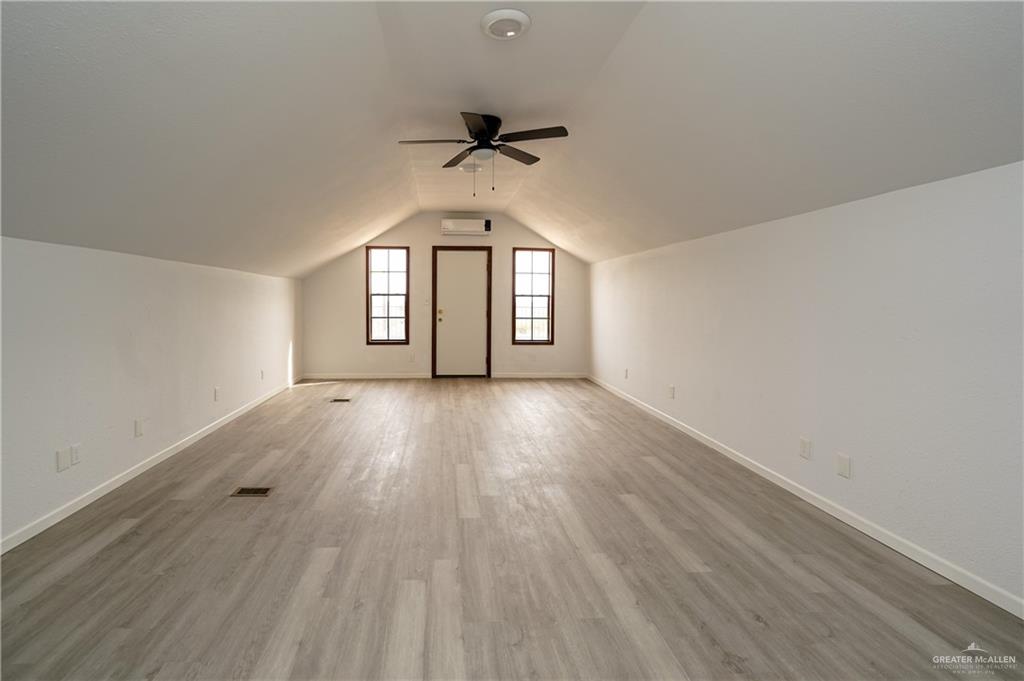 3178 El Campo Road Rio Grande City, TX 78582 - Photo 34 of 40 wooden floor in an empty room with a window