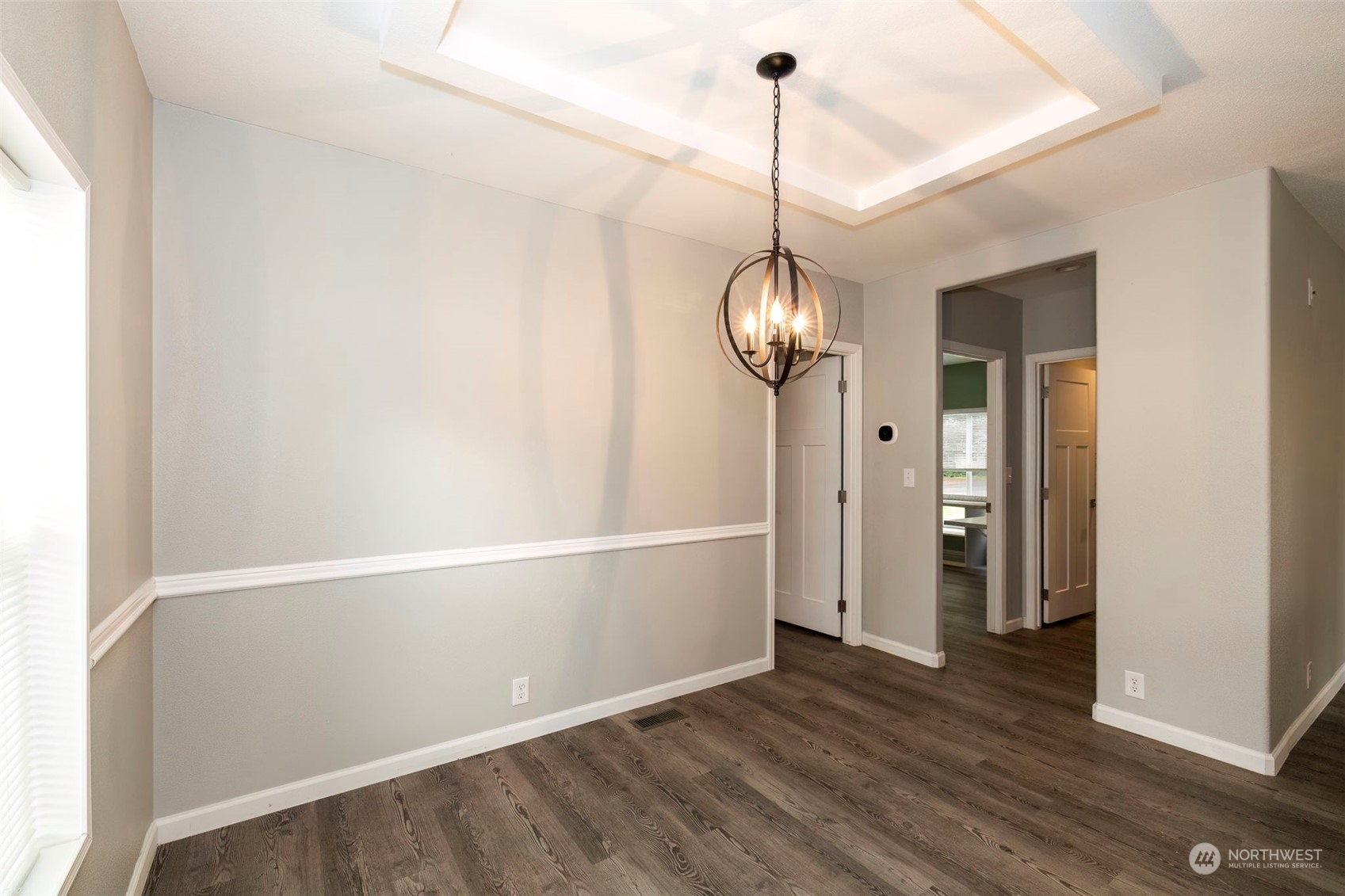 17340 Sargent Road Southwest, Unit 24 Rochester, WA 98579 - Photo 12 of 26 a view of a room with wooden floor and chandelier
