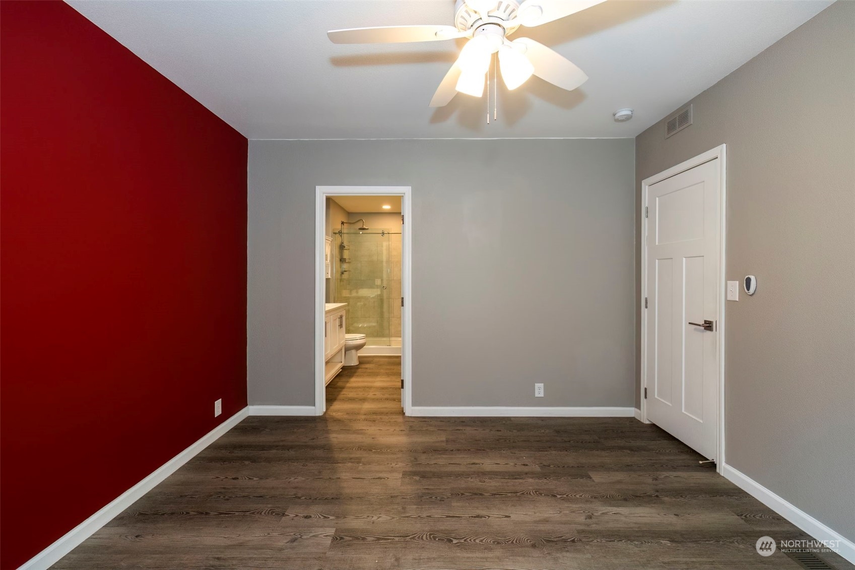 17340 Sargent Road Southwest, Unit 24 Rochester, WA 98579 - Photo 14 of 26 an empty room with wooden floor and door