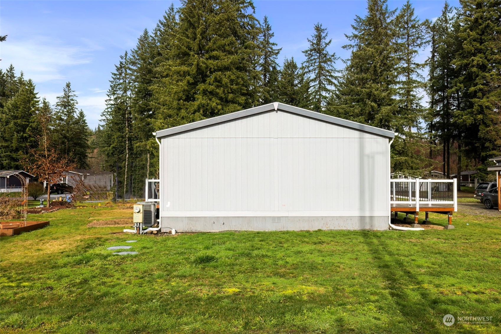 17340 Sargent Road Southwest, Unit 24 Rochester, WA 98579 - Photo 25 of 26 a view of a house with a yard and sitting area