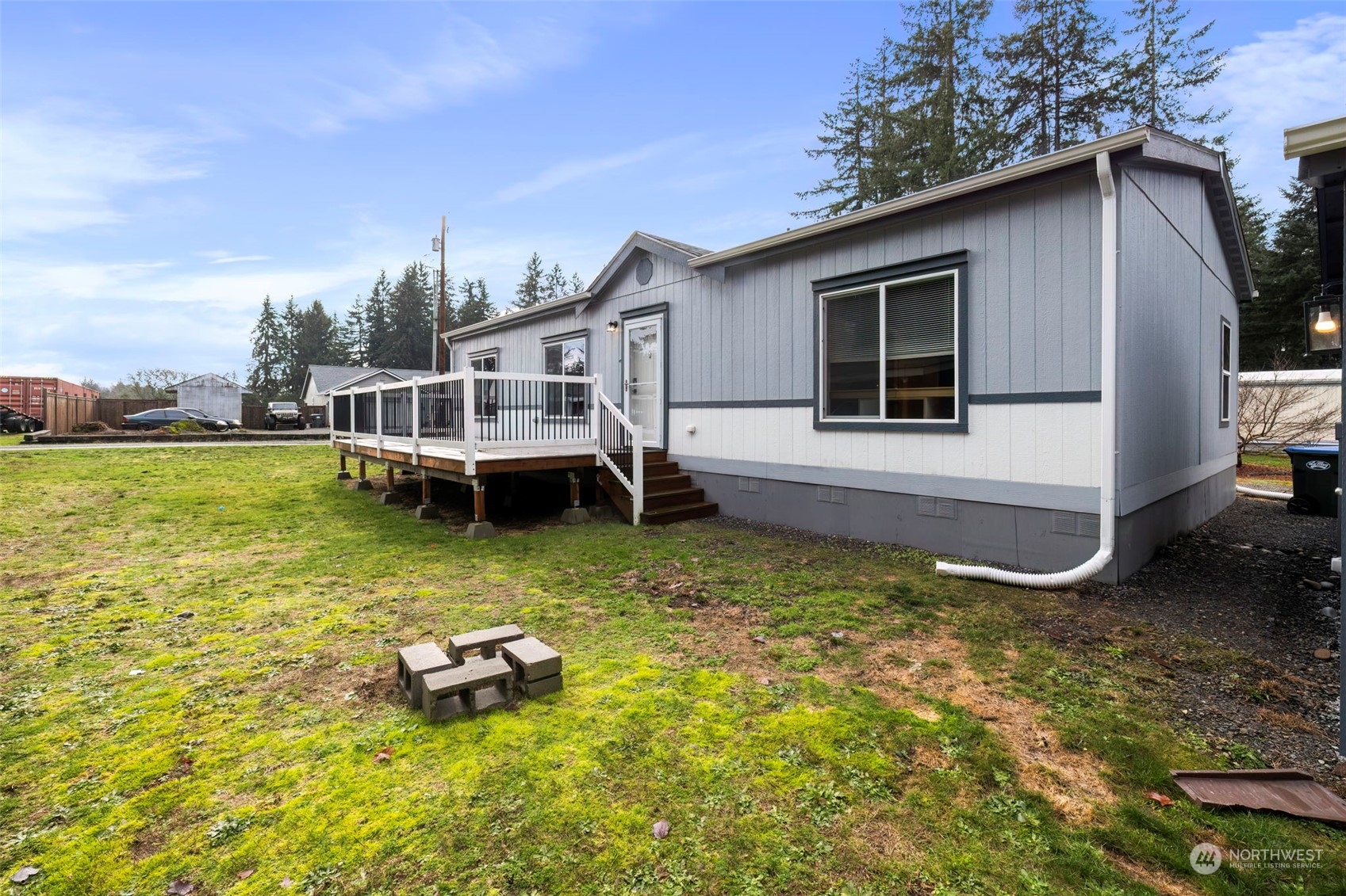 17340 Sargent Road Southwest, Unit 24 Rochester, WA 98579 - Photo 26 of 26 a view of a house with a yard and sitting area