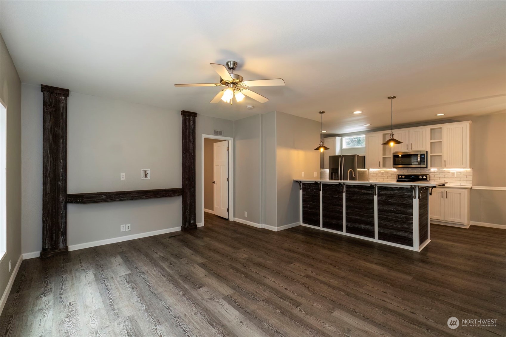 17340 Sargent Road Southwest, Unit 24 Rochester, WA 98579 - Photo 6 of 26 a view of kitchen with wooden floor and window
