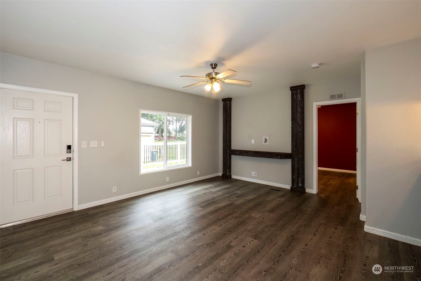 17340 Sargent Road Southwest, Unit 24 Rochester, WA 98579 - Photo 7 of 26 a view of an empty room with wooden floor and a window