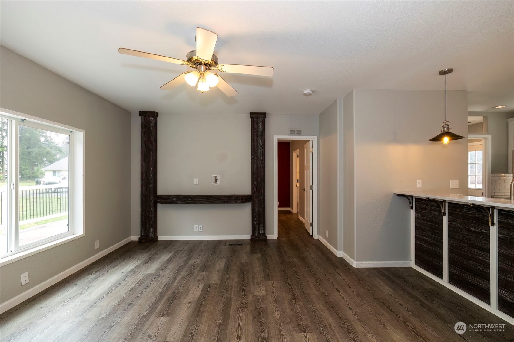 17340 Sargent Road Southwest, Unit 24 Rochester, WA 98579 - Photo 8 of 26 a view of an empty room with wooden floor and a window