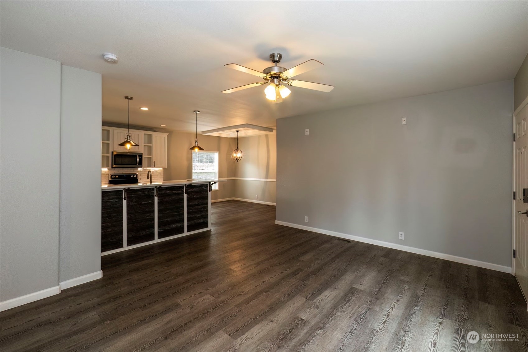 17340 Sargent Road Southwest, Unit 24 Rochester, WA 98579 - Photo 9 of 26 a view of a kitchen with wooden floor and a window